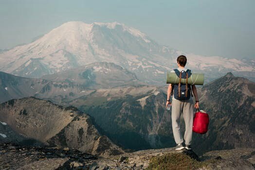 Man on top of mountain looking out