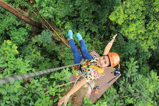 A woman ziplining in hawaii