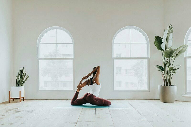 Black woman doing a Naginyasana pose