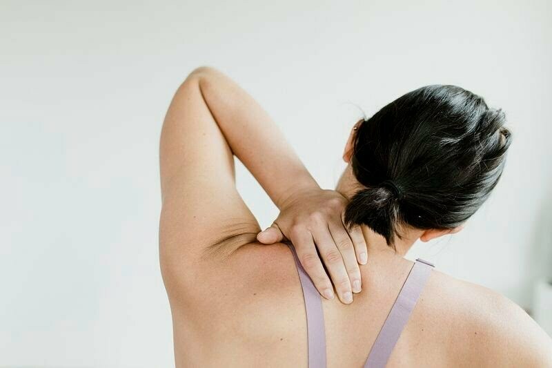 A woman holding her back in pain