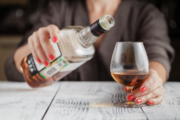 A person pouring a drink of alcohol