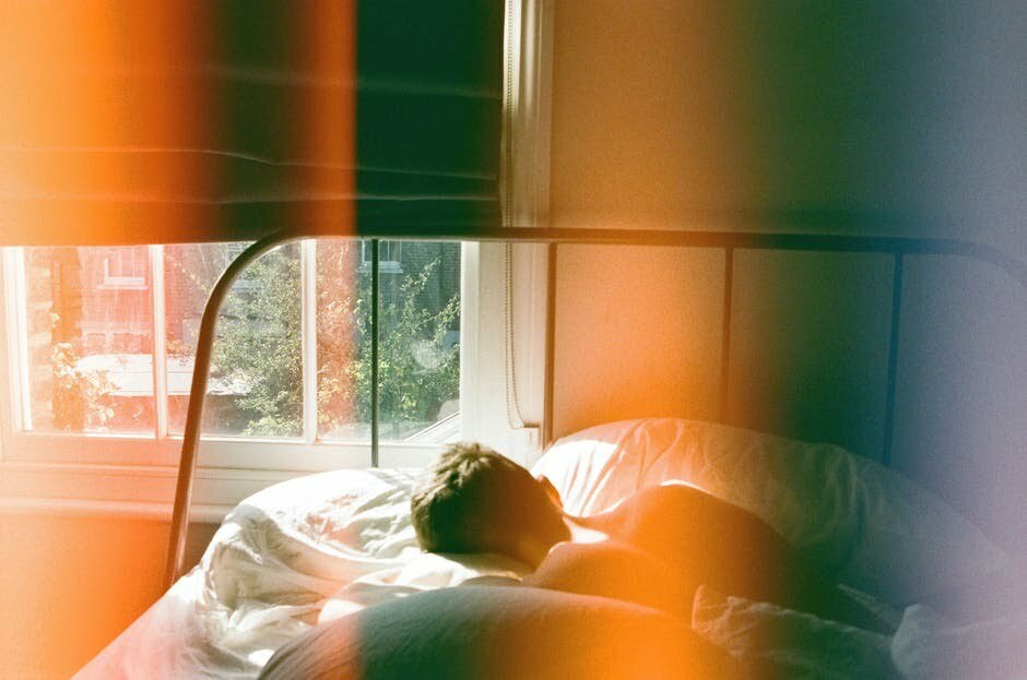 A person in bed struggling with depression