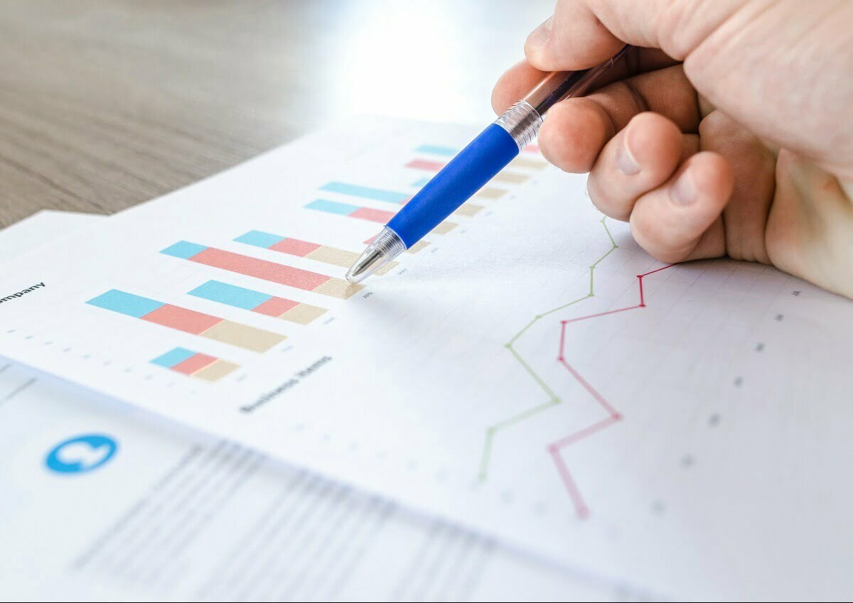 Man showing business graph on wood table
