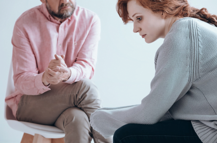 A woman discussing addiction treatments